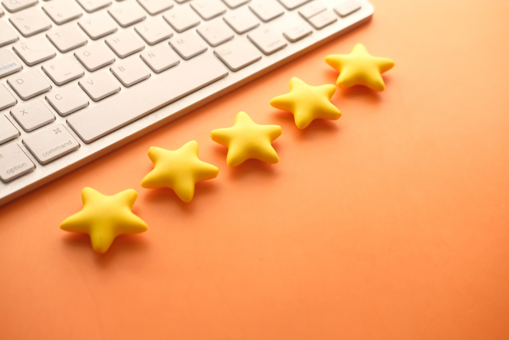 five-star company rating next to a keyboard on orange background